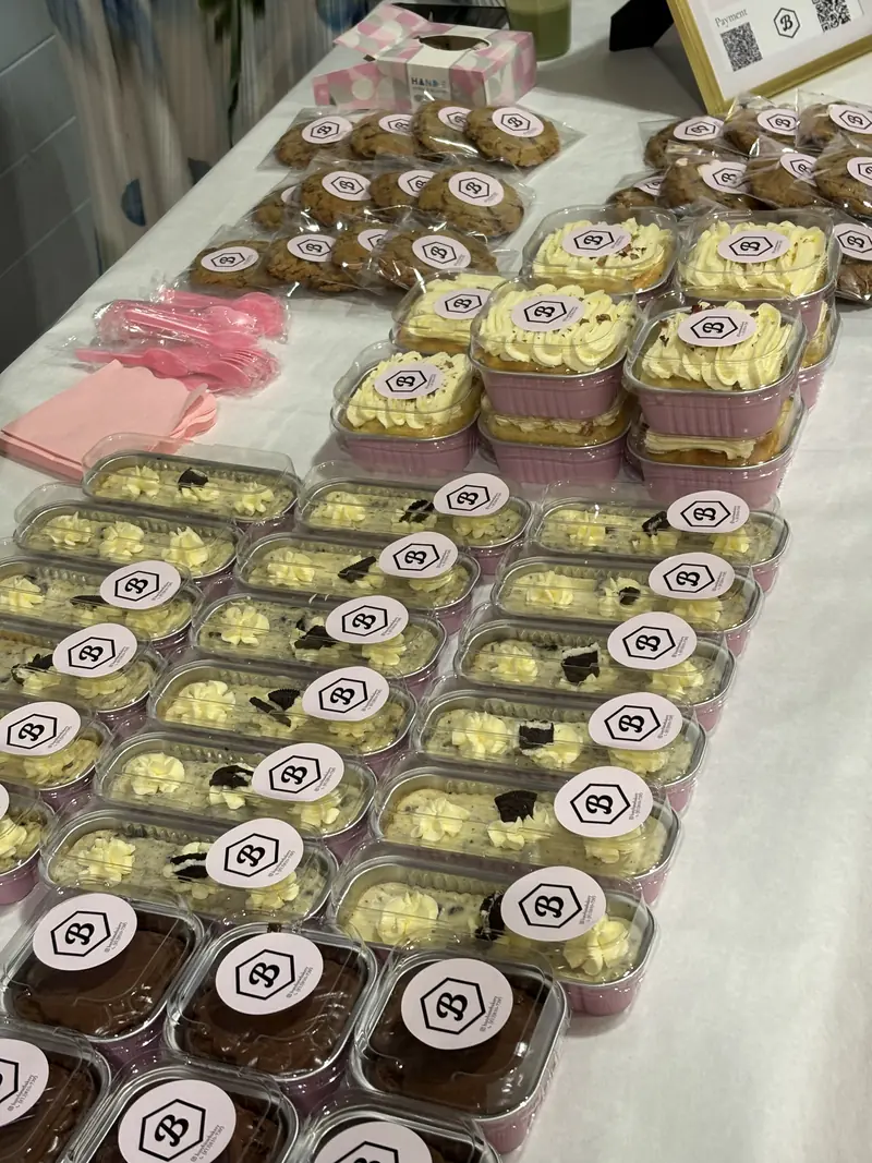 A table of packaged desserts set up for an event